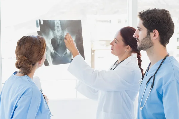 Doctor holding up an x-ray — Stock Photo, Image