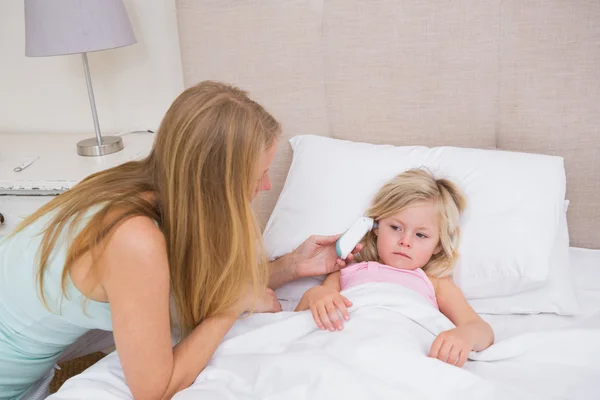 Cute sick girl being looked after — Stock Photo, Image