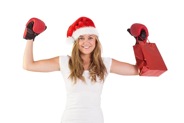 Loira festiva com luvas de boxe e saco de compras — Fotografia de Stock