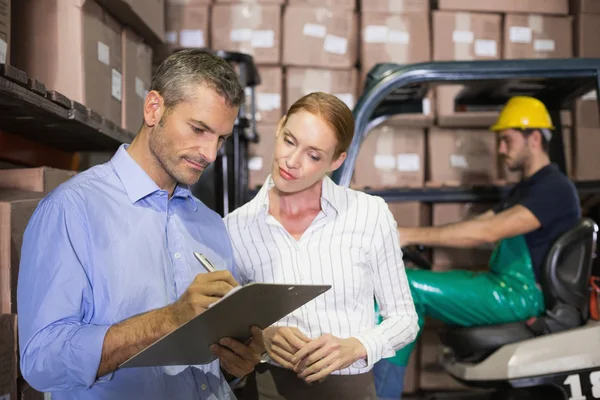 Warehouse team working together with clipboard — Stock Photo, Image