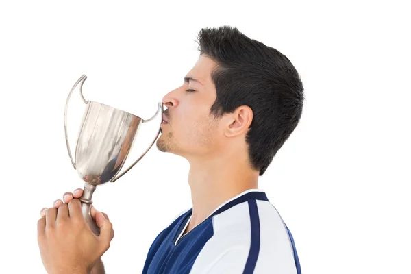 Football player kissing winners cup — Stock Photo, Image