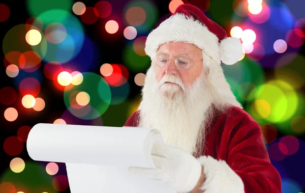 复合图像的圣诞老人检查他的名单 — 图库照片