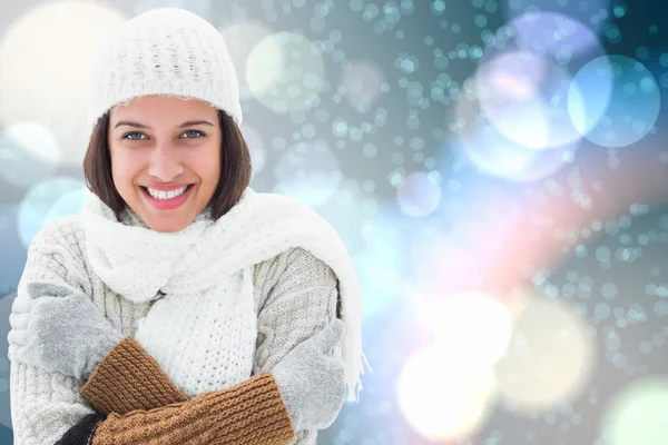 Composite image of brunette in warm clothing — Stock Photo, Image