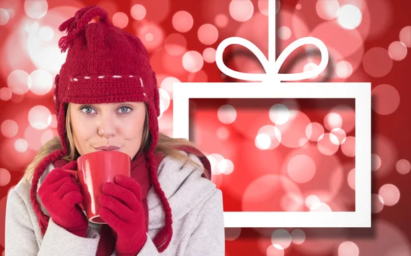 Happy blonde in winter clothes holding mug — Stock Photo, Image