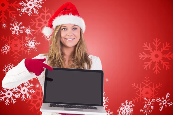 Festive blonde pointing to laptop — Stock Photo, Image