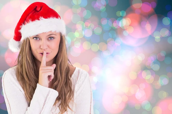 Composite image of festive blonde keeping a secret — Stock Photo, Image