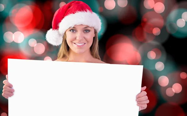 Composite image of festive blonde holding poster — Stock Photo, Image