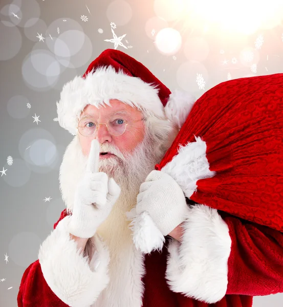 Composite image of santa claus carrying sack — Stock Photo, Image