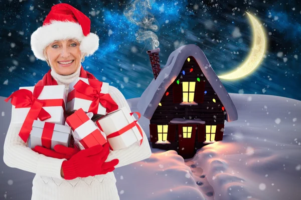 Image composite de femme festive tenant des cadeaux — Photo