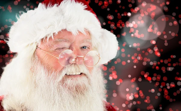 Imagem composta de santa claus piscando — Fotografia de Stock