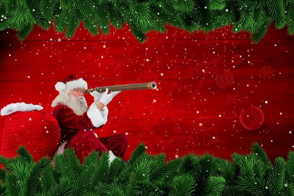 Santa claus patrząc przez teleskop — Zdjęcie stockowe