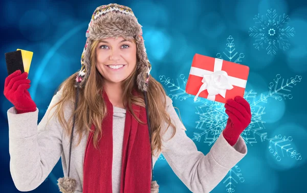 Happy blonde in winter clothes holding gifts — Stock Photo, Image