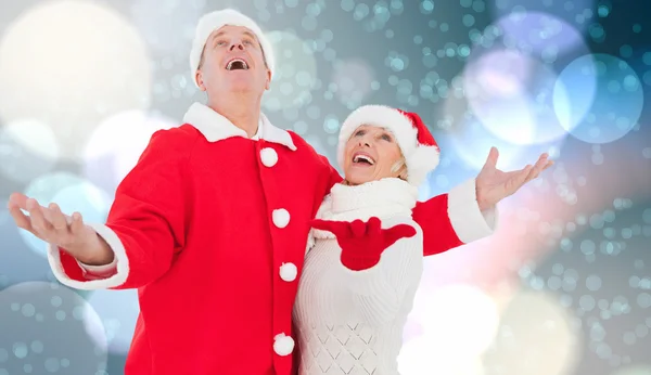 Composite image of festive mature couple — Stock Photo, Image