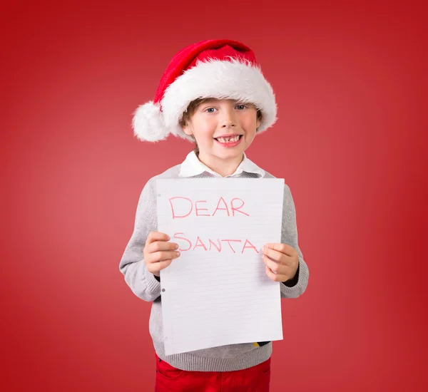 Imagen compuesta de niño festivo mostrando carta — Foto de Stock