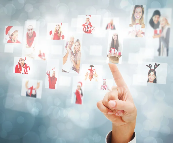 Composite image of hand pointing to christmas people collage — Stock Photo, Image