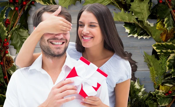 Vrouw verrassende vriendje met cadeau — Stockfoto