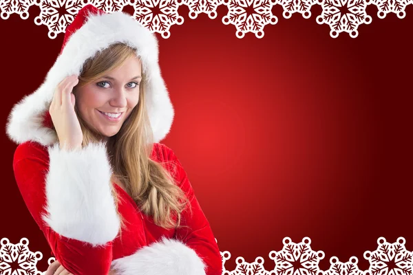 Composite image of festive blonde smiling at camera — Stock Photo, Image