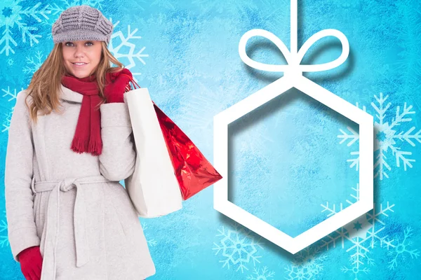 Happy blonde in winter clothes with bags — Stock Photo, Image