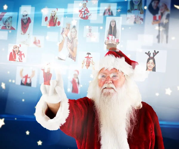 Santa pointing to christmas people collage — Stock Photo, Image