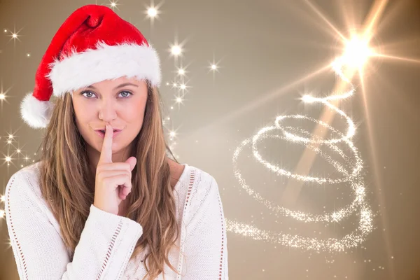 Composite image of festive blonde keeping a secret — Stock Photo, Image