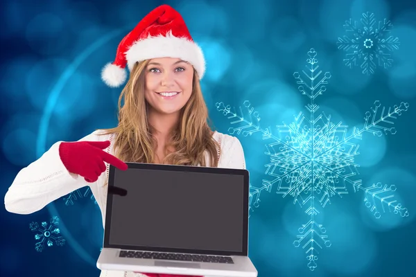 Composite image of festive blonde showing a laptop — Stock Photo, Image