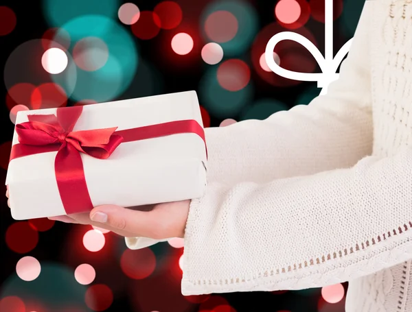 Composite image of woman offering a gift box — Stock Photo, Image