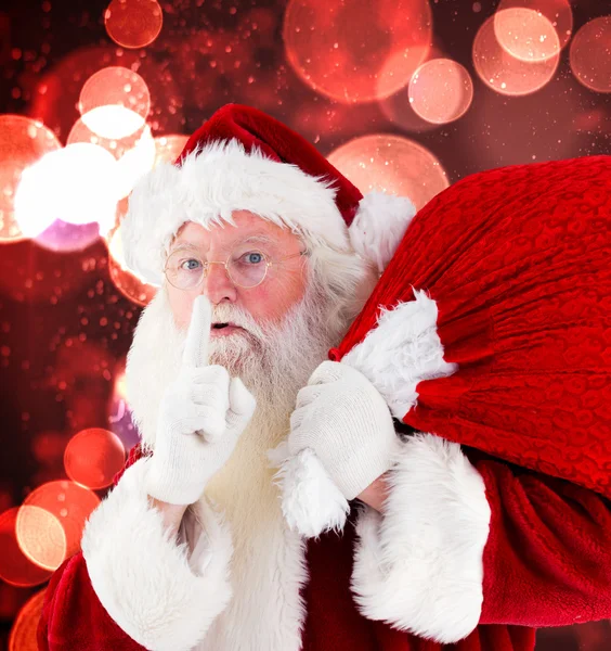 Composite image of santa claus carrying sack — Stock Photo, Image