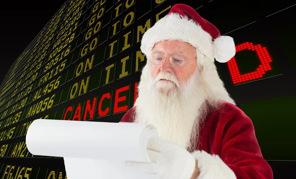 Composite image of santa claus checking his list — Stock Photo, Image