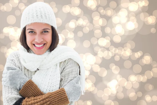 Composite image of brunette in warm clothing — Stock Photo, Image