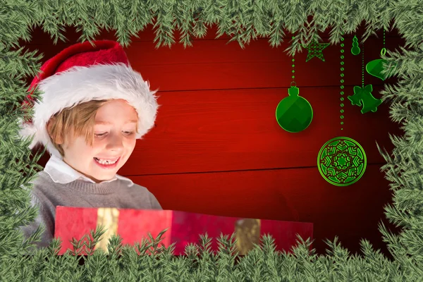 Sammansatt bild av festliga pojke öppning gåva — Stockfoto