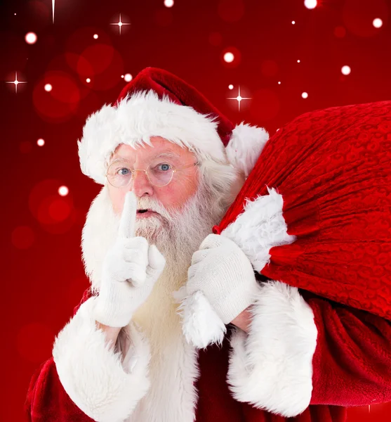 Composite image of santa claus carrying sack — Stock Photo, Image