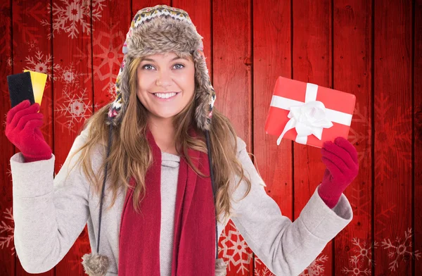 Happy blonde in winter clothes holding gifts — Stock Photo, Image