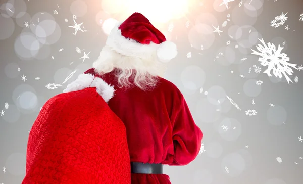 Weihnachtsmann trägt Sack — Stockfoto