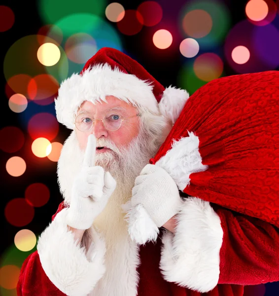 Composite image of santa claus carrying sack — Stock Photo, Image