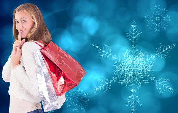 Pretty blonde keeping a secret holding bags — Stock Photo, Image