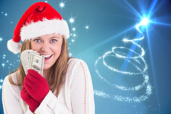 Composite image of festive blonde showing fan of dollars — Stock Photo, Image