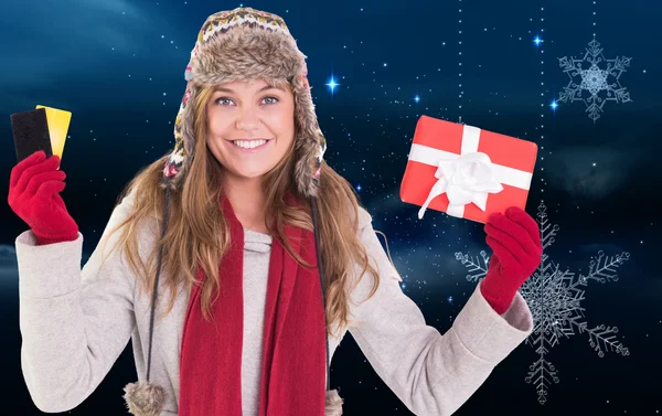 Happy blonde in winter clothes holding gifts — Stock Photo, Image