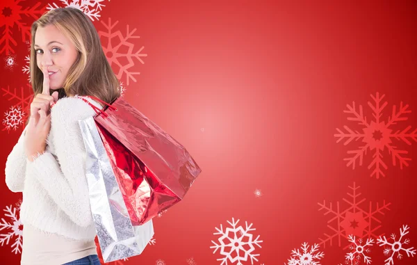 Pretty blonde keeping a secret holding bags — Stock Photo, Image