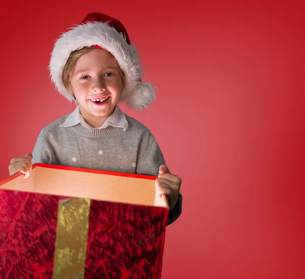 Sammansatt bild av festliga pojke öppning gåva — Stockfoto