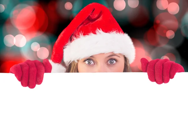 Composite image of festive blonde holding poster — Stock Photo, Image