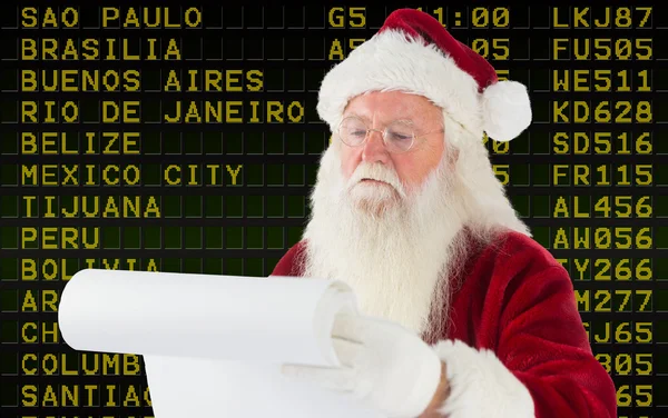 Composite image of santa claus checking his list — Stock Photo, Image