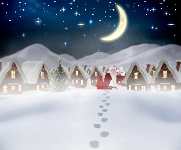 Composite image of santa walking in the snow — Stock Photo, Image