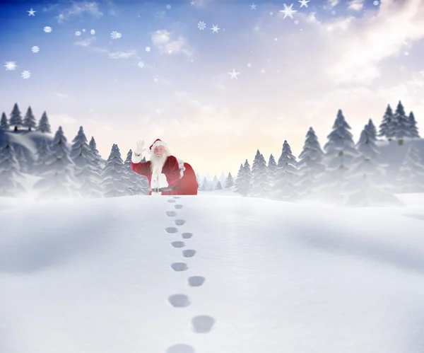 Sammansatta bilden av santa promenader i snön — Stockfoto