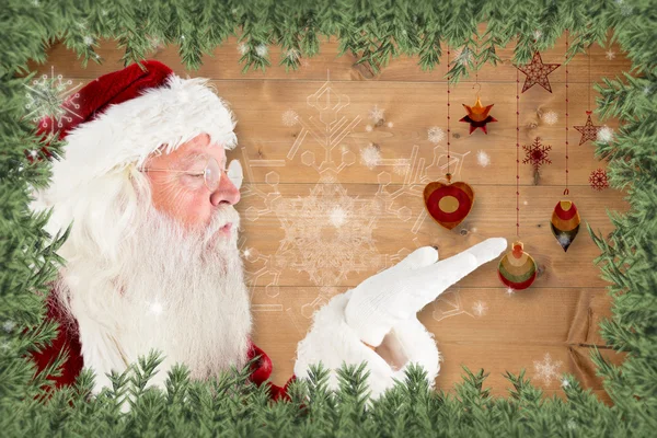 Composite image of santa claus blowing — Stock Photo, Image