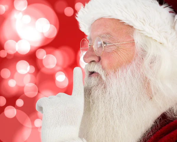 Composite image of santa claus making quiet sign — Stock Photo, Image