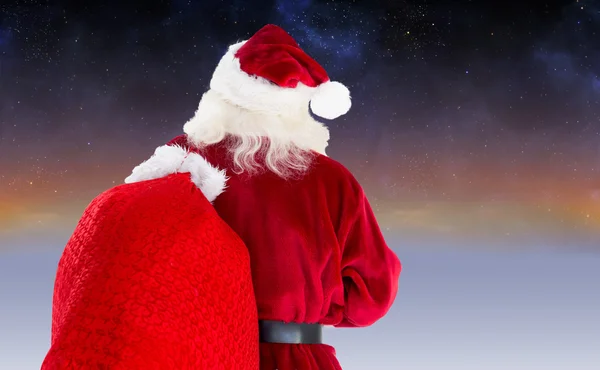 Złożony obraz Świętego Mikołaja prowadzenie worek — Zdjęcie stockowe