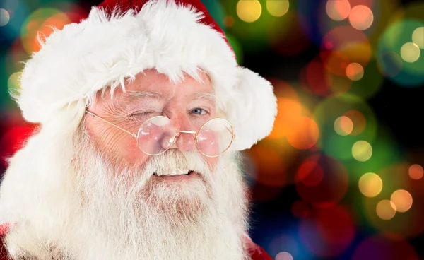 Imagem composta de santa claus piscando — Fotografia de Stock