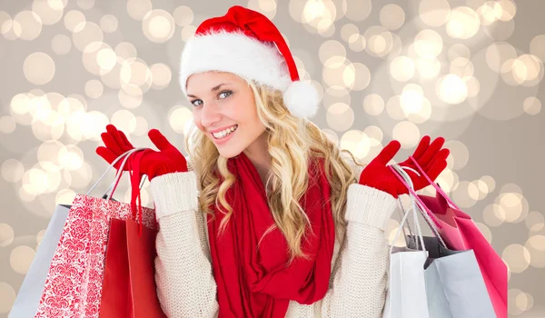 Happy festive blonde with shopping bags — Stock Photo, Image