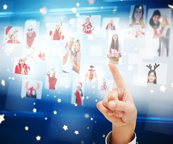 Composite image of hand pointing to christmas people collage — Stock Photo, Image