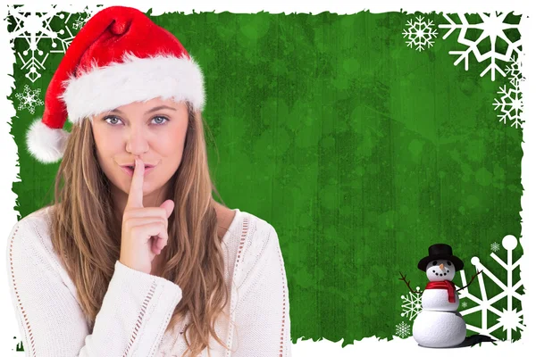 Composite image of festive blonde keeping a secret — Stock Photo, Image